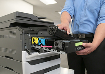 Man changing toner from printer