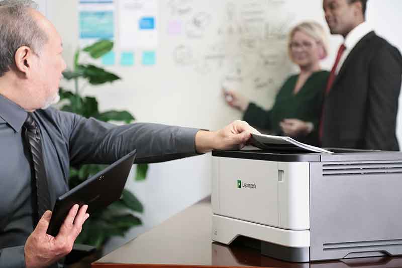 Person removes document from printer.