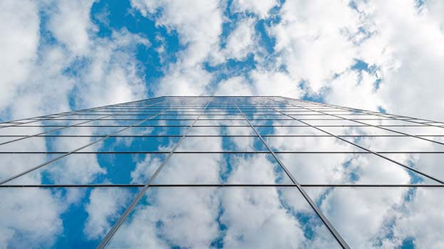 glass building with clouds