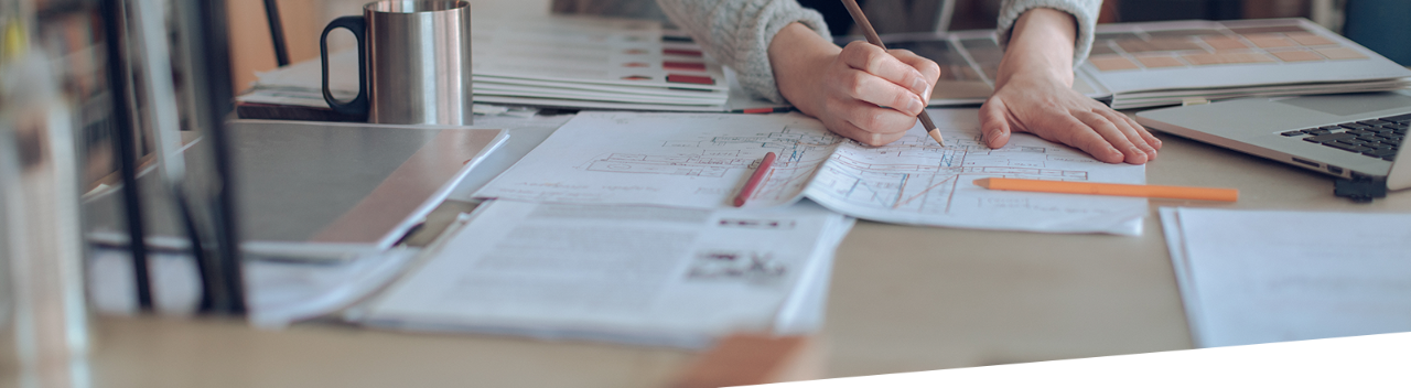 woman making drawing on her printed blueprint
